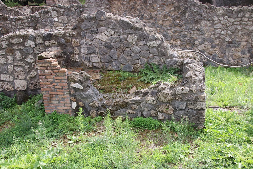 I.1.8 Pompeii. October 2024. Looking south with detail of hearth against south wall of main entrance room. Photo courtesy of Klaus Heese.