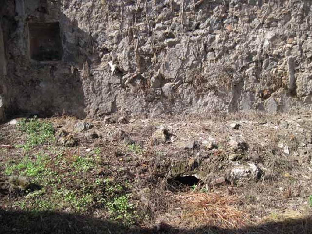 I.2.10 Pompeii. September 2010. Remains of summer biclinium, built against the north wall of the peristyle garden area. Below the north couch was a recess providing storage space. Photo courtesy of Drew Baker.