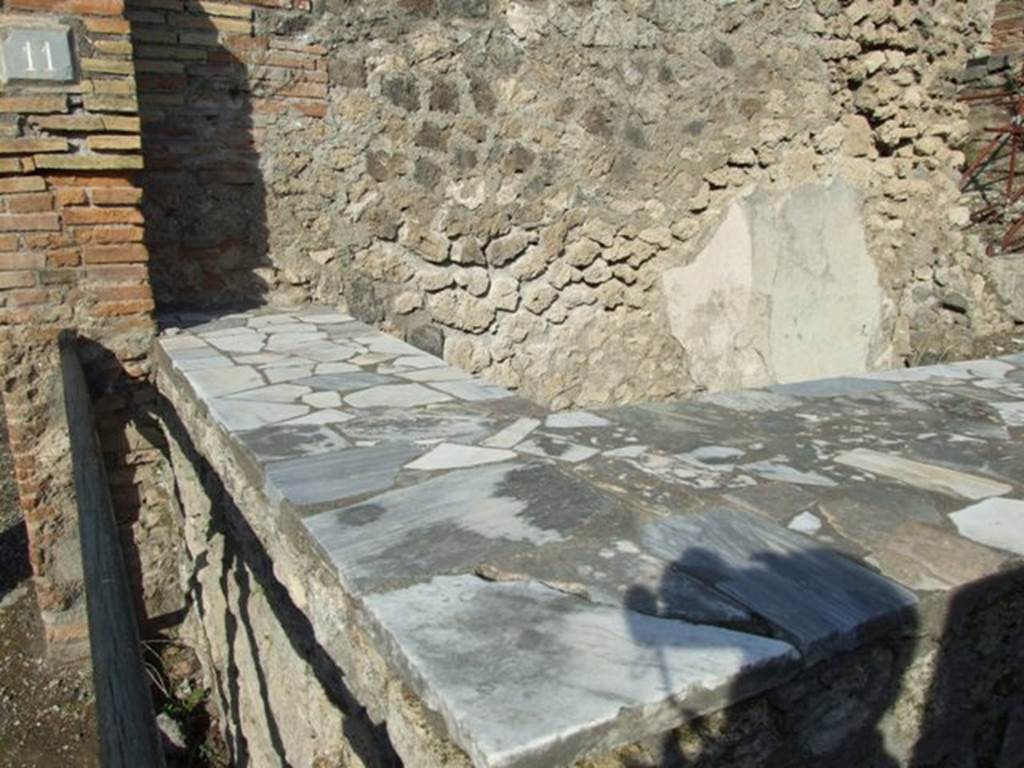 I.2.11 Pompeii.  December 2007.  Counter.  This probably originally had three dolia in the top.  See Van der Poel, H. B., 1986. Corpus Topographicum Pompeianum, Part IIIA. Austin: University of Texas. (p.4).
