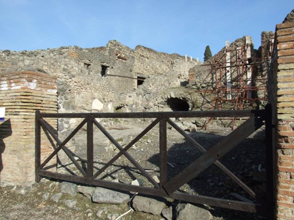 I.2.12 Pompeii. December 2007. Entrance. Looking north-west towards I.2.13. As a result of the bombing of September 1943, the structures of four rooms of these two linked places were destroyed. See Garcia y Garcia, L., 2006. Danni di guerra a Pompei. Rome: L’Erma di Bretschneider. (p.37)
