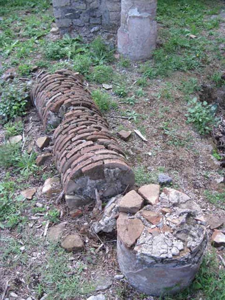 I.2.24 Pompeii. September 2010. Detail of fallen brick column on west side of atrium, looking west. Photo courtesy of Drew Baker.
