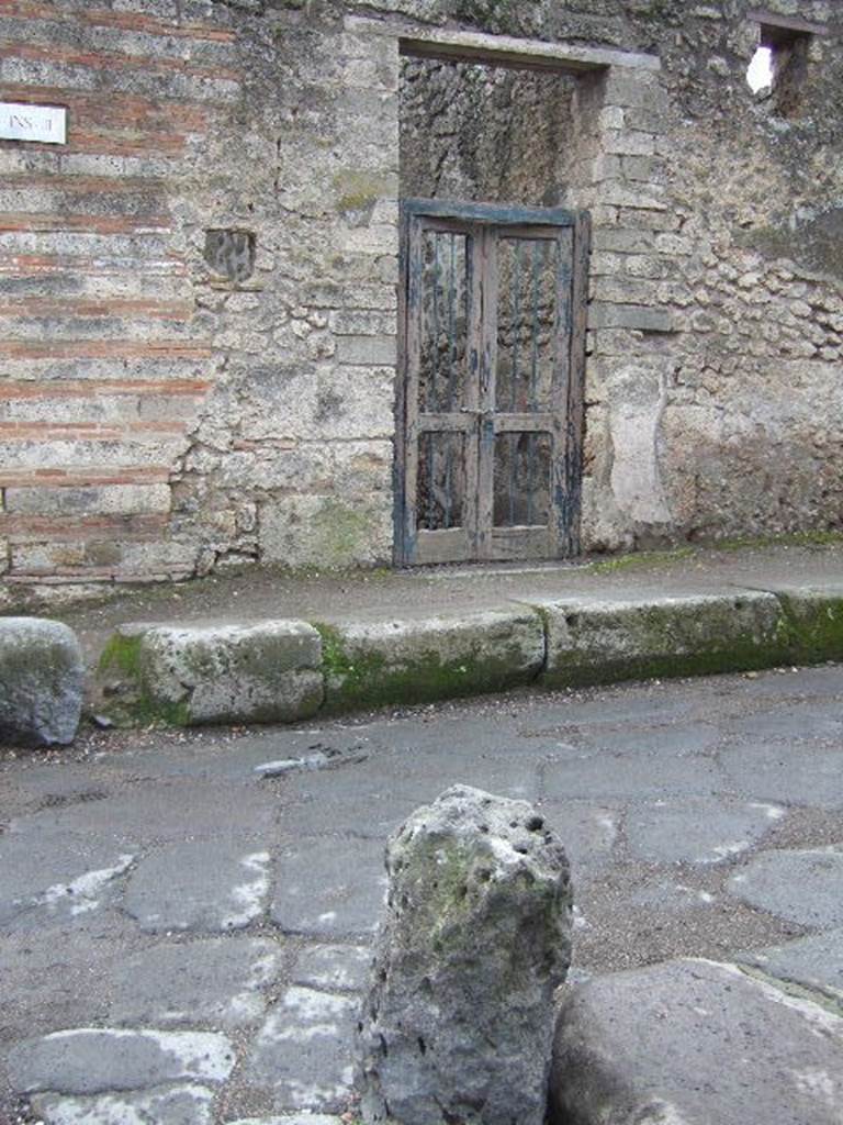 I.3.24 Pompeii. December 2006. Entrance on corner of  Vicolo del Menandro.  According to Della Corte, on the wall on both sides of the entrance were paintings of Mercury and Hercules. He thought the house belonged to the unknown Capella, because of the graffiti, still partly legible in the 1960�s. On the left of the entrance:

L(ucium)  Ceium  Secundum  aed(ilem)
Cape
lla  rog(at)       [CIL IV 2993g]       

Capella  va(le)      [CIL IV 3200aa] and Note 3 on p.269.
See Della Corte, M., 1965.  Case ed Abitanti di Pompei. Napoli: Fausto Fiorentino. (p.269)
