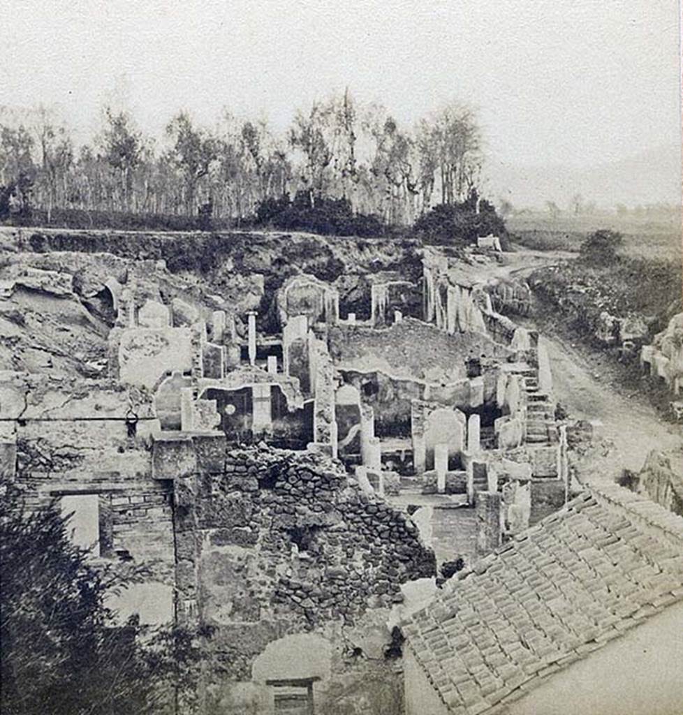 I.4.2 Pompeii. Detail from stereoview by R. Rive, c.1860-1870�s.
Looking across atrium towards peristyle at rear, and steps in south-east corner (all above the rebuilt roof in the right hand lower corner of the picture). 
At the rear of the east wall of the peristyle would be the lower (third) peristyle of 1.4.5/25.
Photo courtesy of Rick Bauer.
