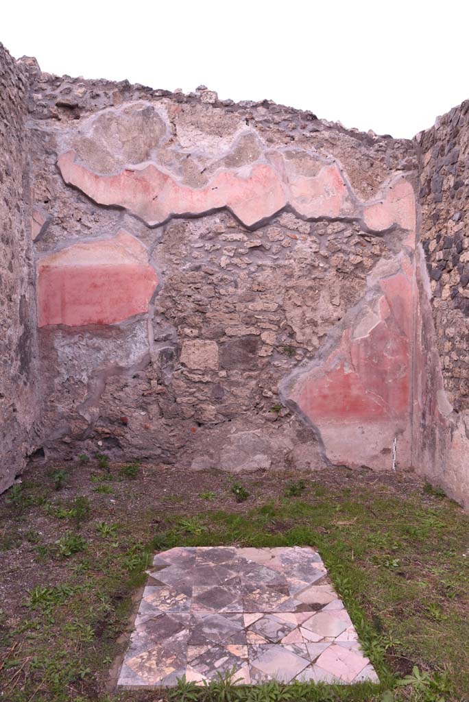 I.4.9 Pompeii. October 2019. Triclinium/oecus m, north wall.
Foto Tobias Busen, ERC Grant 681269 D�COR.
According to PPM �
�The north wall was perforated by explorers penetrating the house in search of materials useful for reconstruction after the eruption of 79AD, of the central aedicula in the rear wall only the triangular tympanum remained, which rises up to the upper red area punctuated by slender architectures.
With regard to the flooring, the position of the table in the middle of the three couches in the triclinium was given this carpet of squares and triangles of coloured marble.� (1977).
See Carratelli, G. P., 1990-2003. Pompei: Pitture e Mosaici. I. Roma: Istituto della enciclopedia italiana, (p. 180).
