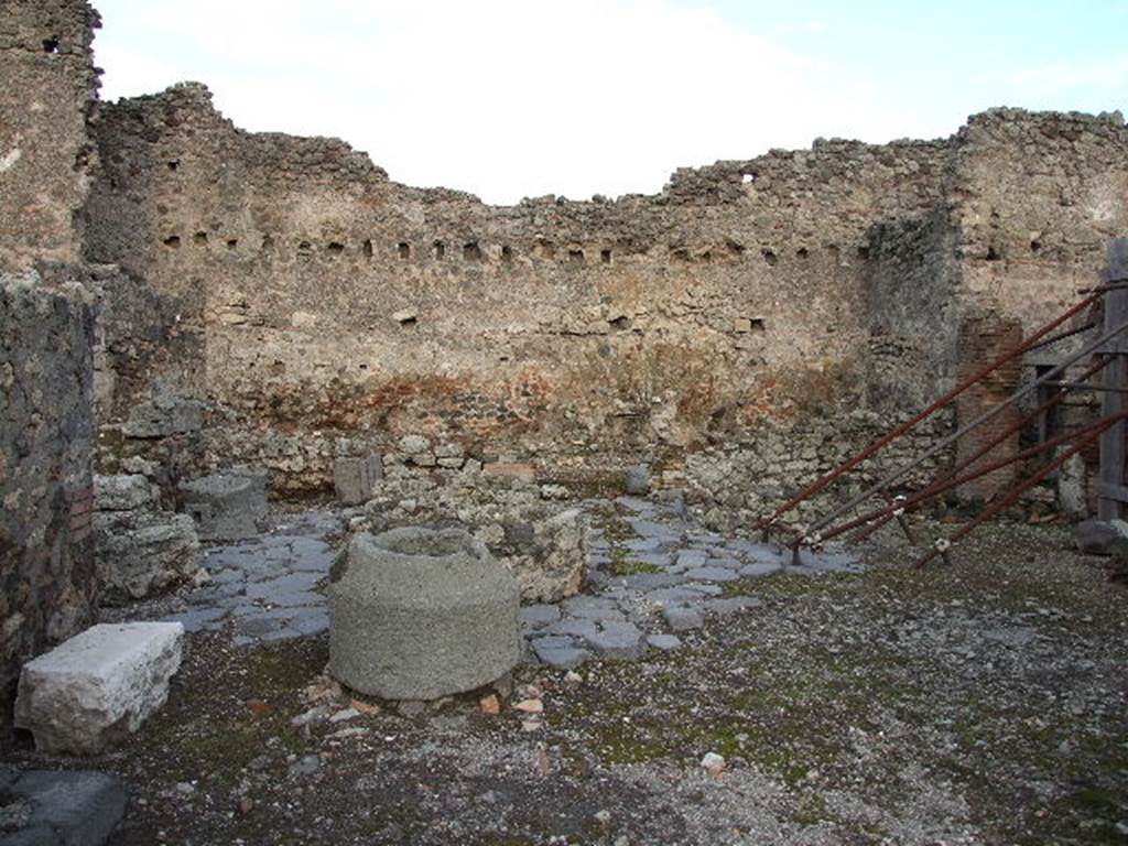 I.4.12 Pompeii. December 2006. Room b, bakery room. Looking towards rear room on east side of bakery, room f.

