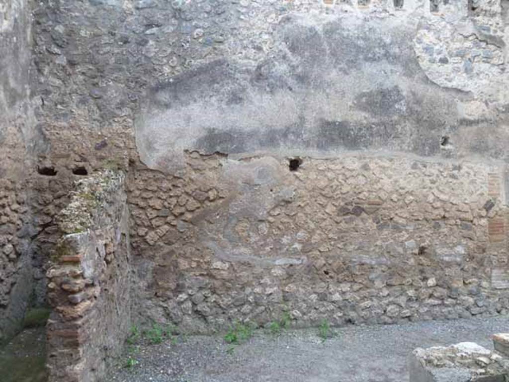 I.4.27 Pompeii. May 2010. West wall of front bar or sales-room, with latrine in the south-west corner.