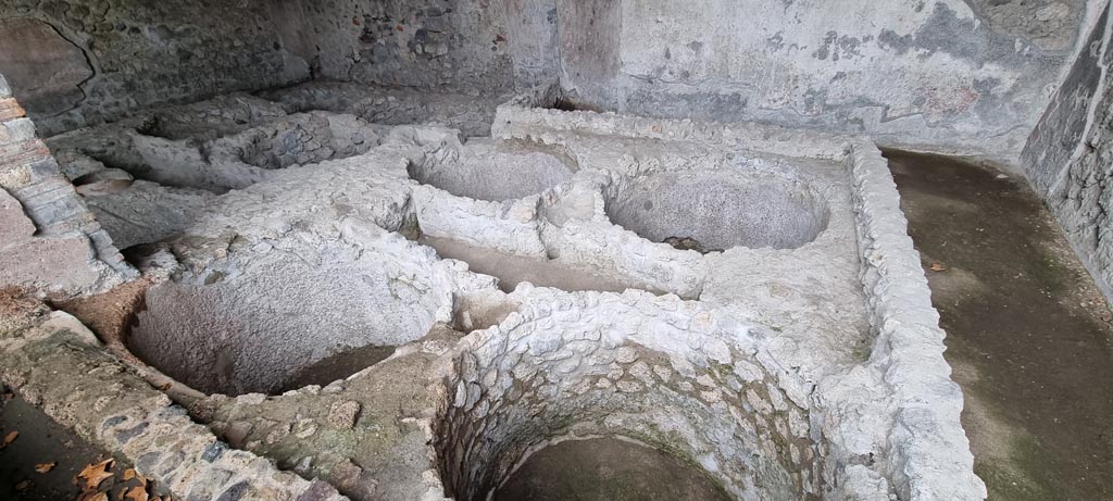 I.5.2 Pompeii. December 2023. Looking south-east towards round vats in industrial room. Photo courtesy of Miriam Colomer.