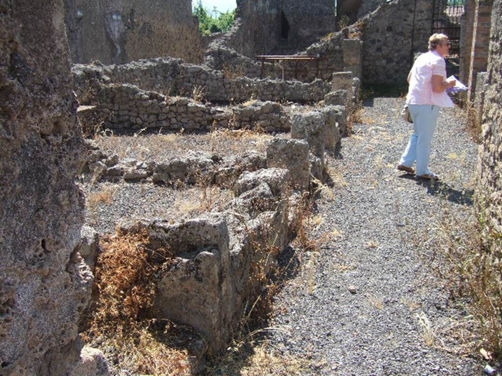 I.6.2 Pompeii. May 2006.  Rooms on the east side, looking south. Looking south along passage between the atrium and the peristyle garden. Two bombs fell on the house on the 19th September 1943. These rooms, the eastern ala and the next four rooms together with the eastern perimeter wall were destroyed. See Garcia y Garcia, L., 2006. Danni di guerra a Pompei. Rome: L’Erma di Bretschneider. (p. 41).
