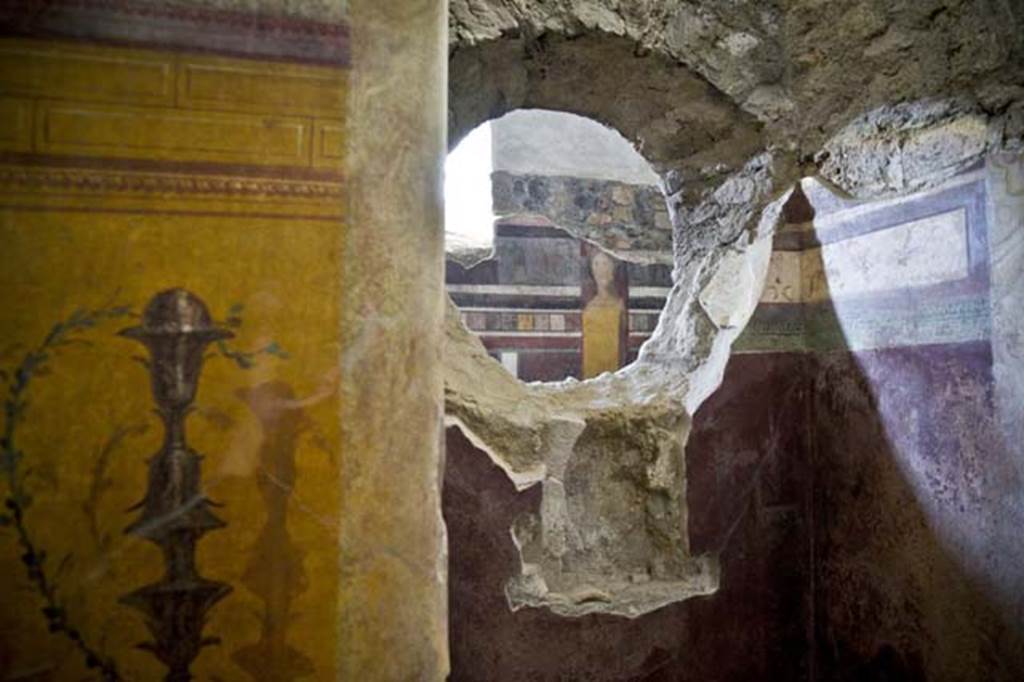 I.6.2 Pompeii. December 2015. West wall of frigidarium. 
Niche in west wall with painting of candelabrum.
At the rear, through the window, the west wall of the east wing of the cryptoporticus can be seen.
