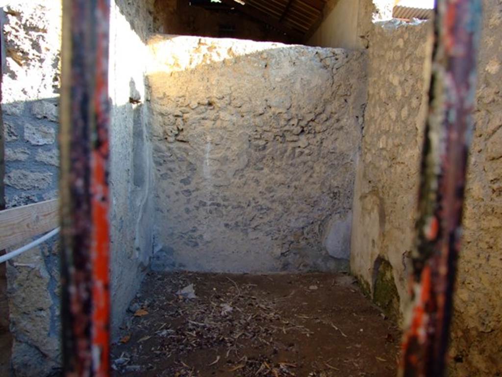 I.6.4 Pompeii. March 2009. Room 12, on the left (east side) is the doorway into room 11.
Ahead is the south wall of room 12, at the rear of this is the small cubiculum with a mosaic floor.
The small cubiculum has not been photographed.
According to Kuivalainen in an alcove in the east wall of the small cubiculum, he describes –
“A composition of two figures painted with white on a red background. On the left, a half reclining robed female figure with her head inclining towards her right shoulder. The youth on the right side advances energetically, stepping with his left leg over the female’s legs, with a pedum in his left hand.”
Kuivalainen comments –
“Bacchus, with a pedum in hand, approaching a sleeping Ariadne would be a rare subject. ……………………….”
See Kuivalainen, I., 2021. The Portrayal of Pompeian Bacchus. Commentationes Humanarum Litterarum 140. Helsinki: Finnish Society of Sciences and Letters, (p.144, E4).