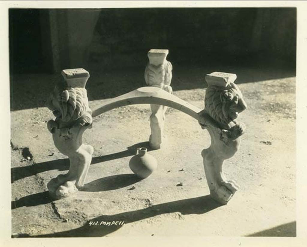 I.6.11 Pompeii. 1932. Marble tripod table legs with lion heads and paws, in atrium. Photo taken during a shore-visit from the ship Resolute’s world cruise in 1932. Photo courtesy of Rick Bauer.