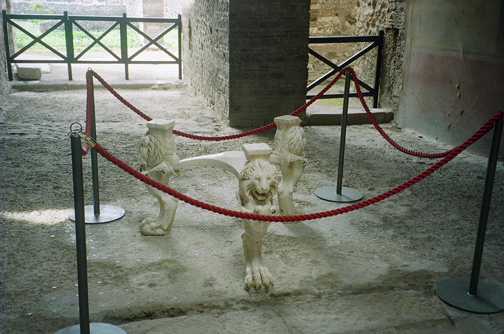 I.6.11 Pompeii. May 2010. Marble tripod table legs with lion’s heads and paws.
The inscription on the top of each leg identifies the table as having belonged to Casca Longus.
He was the first assassin to strike Caesar in the Senate in 44BC. He died in 42BC along with Brutus at the Battle of Philippi in Macedonia.
His lands and possessions were confiscated and publicly sold.
The table was then or sometime later bought by the owner of this house. Photo courtesy of Rick Bauer.