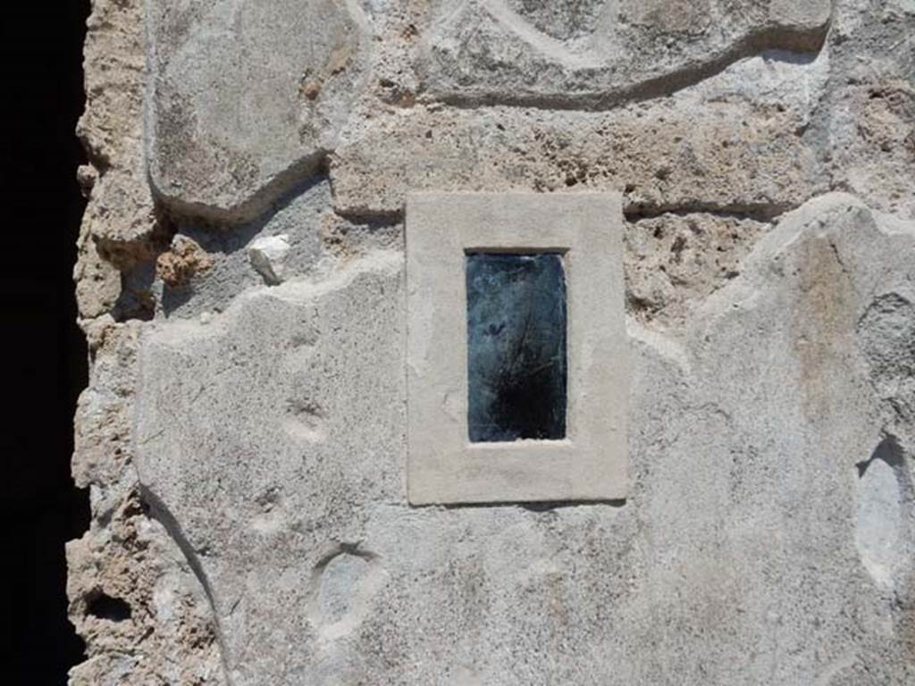 I.7.11 Pompeii. May 2017. Obsidian mirror on east wall of atrium. Photo courtesy of Buzz Ferebee.
