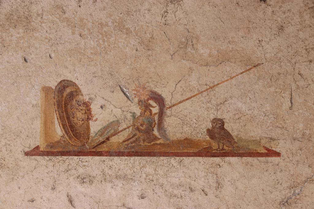 I.7.11 Pompeii. September 2021. 
Detail of wall painting of the attributes of Minerva/Athena in centre panel of north wall. Photo courtesy of Klaus Heese.

