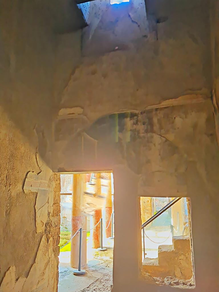 I.7.19 Pompeii. March 2024. 
West end of south wall, on left, and west wall with window and doorway to pseudoperistyle.
Photo courtesy of Giuseppe Ciaramella.

