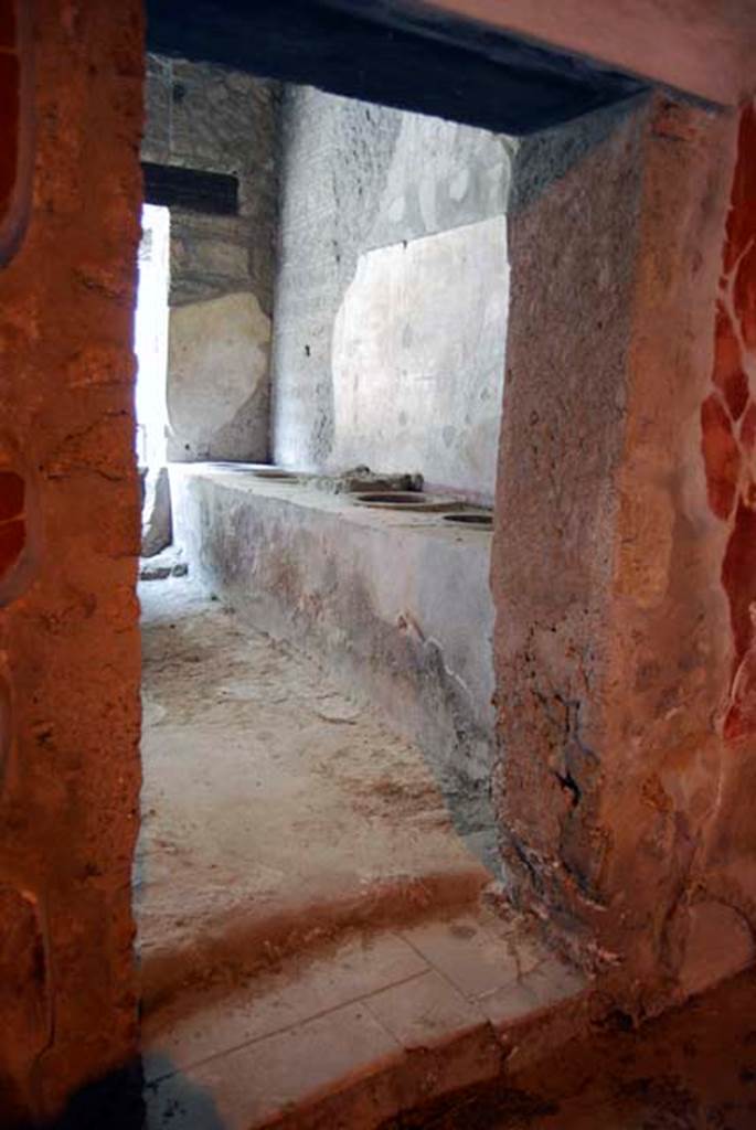 I.8.9 Pompeii. Room 3, looking through doorway in north wall, towards east wall of caupona. Photo courtesy of Paula Lock.