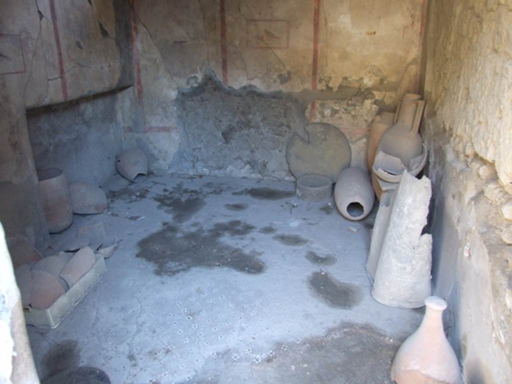 I.8.9 Pompeii. March 2009. Room 4, looking east across decorative floor in cubiculum. 
According to PPM, the floor of the anteroom and alcove was in cocciopesto with pattern made by white and black tesserae. In the anteroom was a “carpet” pattern of crosses with a black centre, bordered by a row of white and black alternating tesserae, the edge of the recess was a net of diamonds edged by a a similar row of alternating black and white tesserae, and the alcove itself was of scattered white tesserae.
