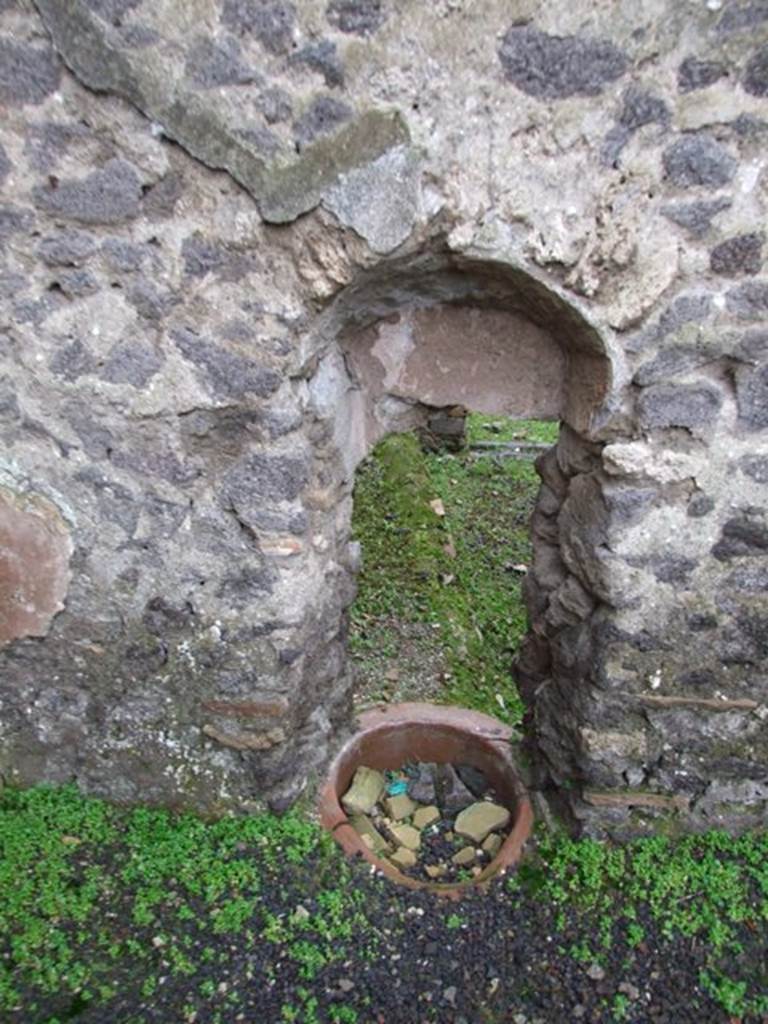 I.8.14 Pompeii. December 2007. 
Courtyard 7, west wall with recess with terracotta pot at base and view through to I.8.15/16.

