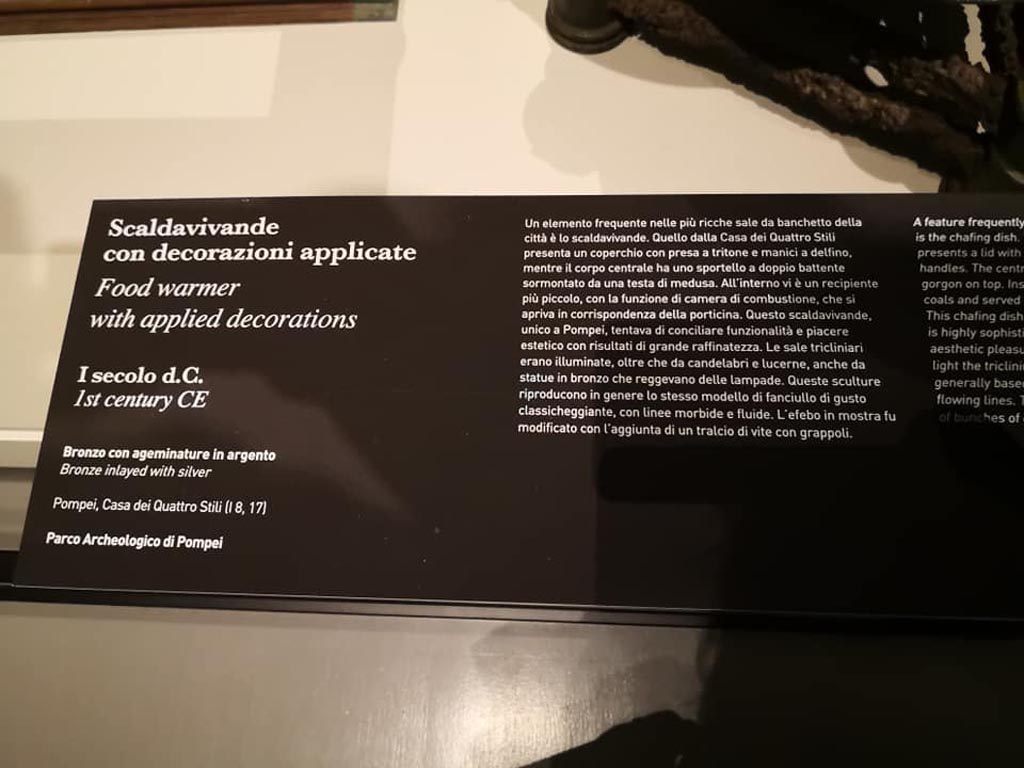 I.8.17 Pompeii. December 2019. Information card with food warmer.
On display in exhibition “Pompei e Santorini” in Rome, 2019. Photo courtesy of Giuseppe Ciaramella.