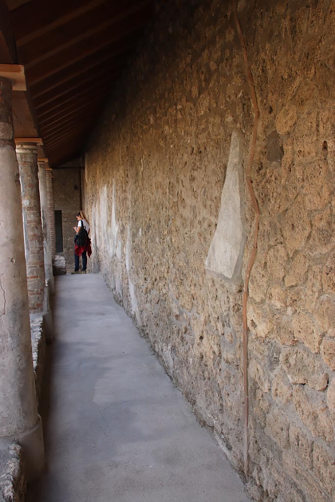 I.9.14 Pompeii. October 2022. 
Room 1, looking south along colonnaded portico on west side of upper garden area. Photo courtesy of Klaus Heese.

