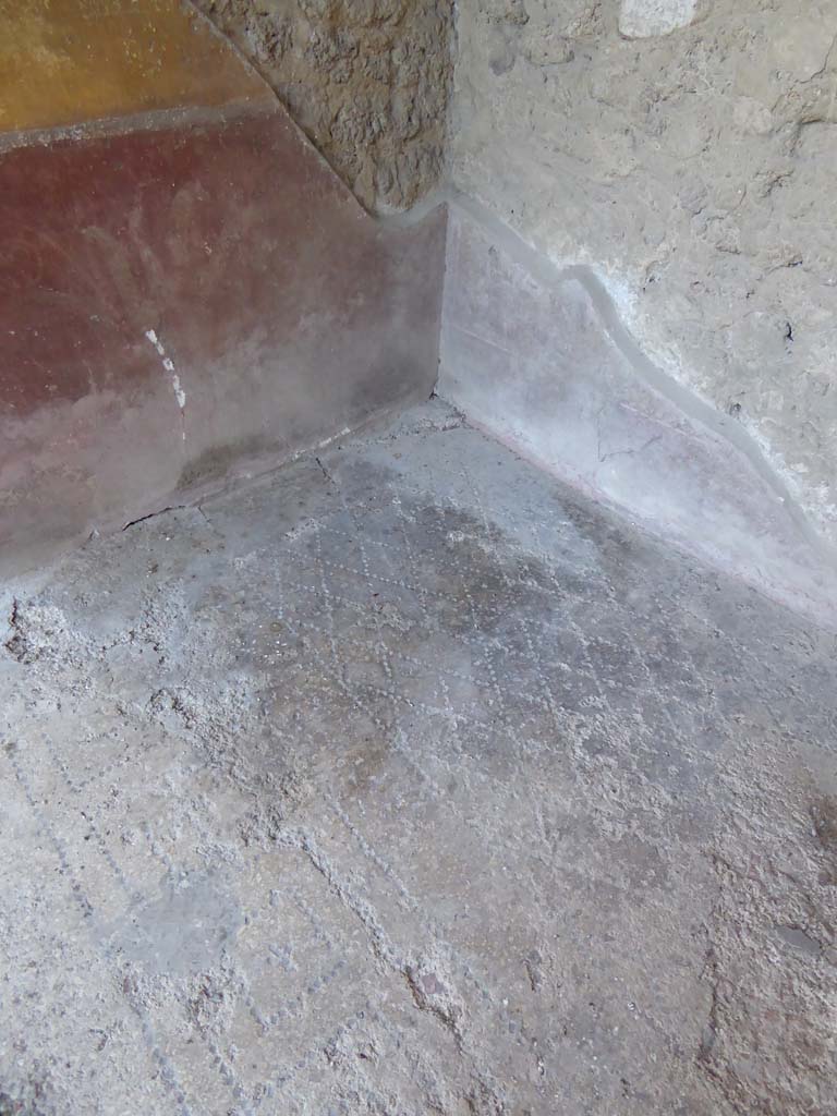 I.10.4 Pompeii. September 2018. 
Alcove 23, looking towards red zoccolo with painted plant from lower east wall, and across flooring.  
Foto Annette Haug, ERC Grant 681269 DÉCOR.

