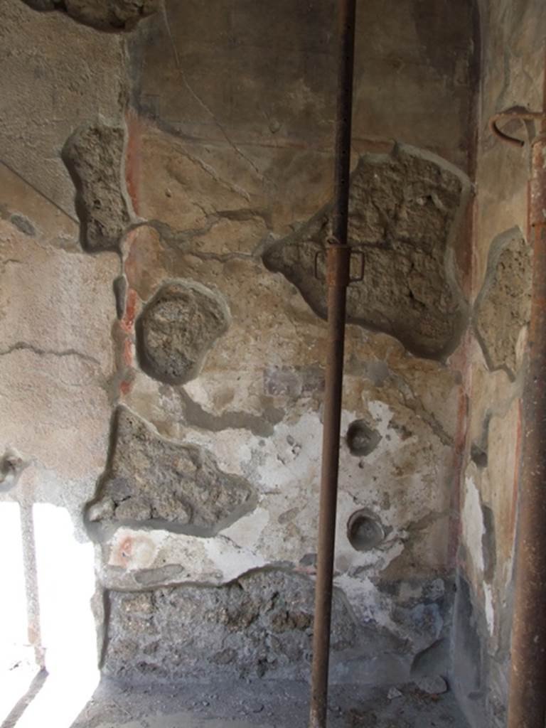 I.10.11 Pompeii. March 2009. Room 10, north wall of peristyle.
According to PPP, this is the site of a graffito, CIL IV 8404a.
The remains of this are located on the edge of the plaster just left of the bracket on the metal upright.  
See Bragantini, de Vos, Badoni, 1981. Pitture e Pavimenti di Pompei, Parte 1. Rome: ICCD. (p.144)

According to Epigraphik-Datenbank Clauss/Slaby (See www.manfredclauss.de), this read -

Venus       [CIL IV 8404a]
