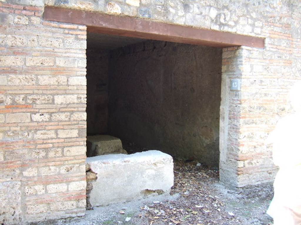 I.10.13 Pompeii. September 2005. Entrance doorway.
According to NdS, -
This wide doorway, with a wooden threshold and brick door-jambs, led into a rectangular room (6.10m x 3.50m) with walls covered by a high cocciopesto zoccolo, and upper walls plastered, the flooring was cocciopesto, and the ceiling was flat. 
In the west wall, other than a bricked-up doorway communicating with one of the rustic rooms of the Casa del Menandro, the first brick steps of a wooden stairs leading up to the mezzanine was found in the south-west corner. 
The threshold was occupied with two thirds of the short side of the brick counter covered in cocciopesto and painted red, having the hearth at the west end of the long side and two small clay dolia embedded into it.
For the finds, found on this counter, see NdS, 1934, p.340.
For details of �finds� from this house, 
See Allison, P.M. (2006). The Insula of the Menander at Pompeii: Vol. III The finds, Clarendon Press, Oxford, (p.248 & p.367).


