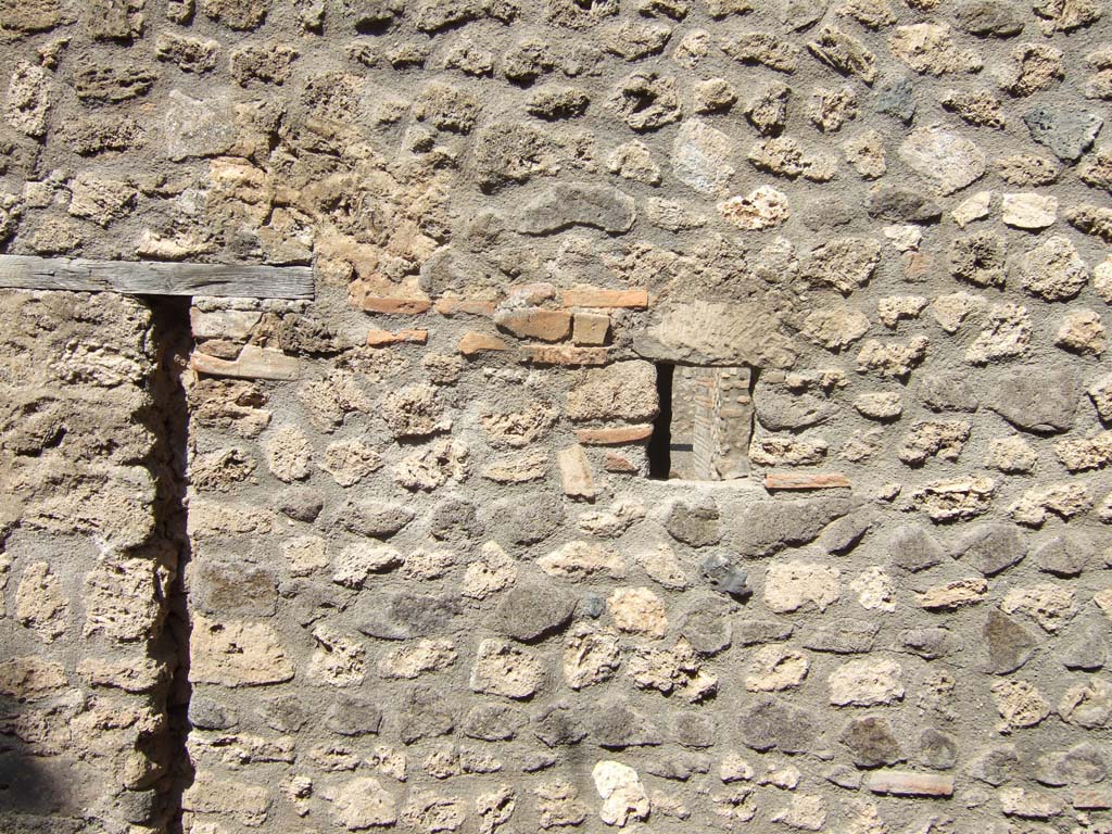 I.10.14 Pompeii. September 2005. Looking north towards exterior south wall with blocked doorway into latrine, on left.