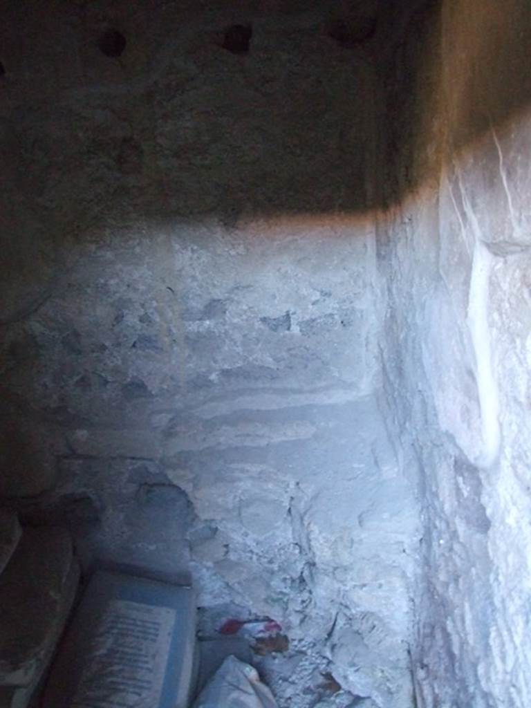 I.10.16 Pompeii. March 2009. Looking south across part of  L-shaped Kitchen, the part facing west. Remains of masonry platform or hearth.
