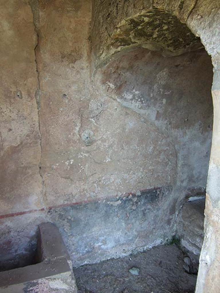 I.11.10 Pompeii. September 2005. Latrine with small water basin.
According to Hobson, this latrine which had its entry from the garden, was a rarity in Pompeii as it had its own water tank. 
The room was decorated with a black dado topped by a red-line, making it one of the few well decorated latrines. (Jansen 1993).
See Hobson, B., 2009. Latrinae et foricae: Toilets in the Roman World. London; Duckworth. (p. 122).
