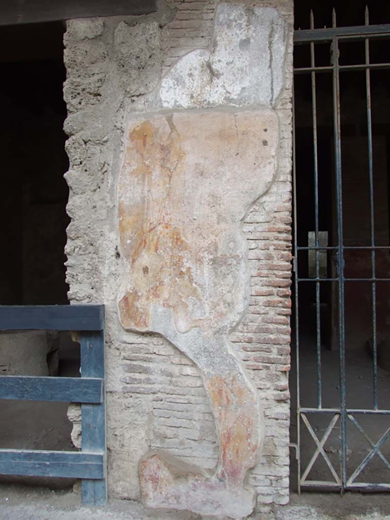 I.12.3 Pompeii. December 2006. Plaster on wall to east of door.
