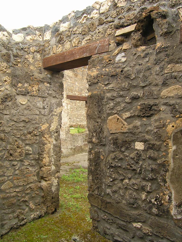 I.14.2 Pompeii. July 2008. Room E, north wall with doorway to atrium in north-west corner.
Photo courtesy of Guilhem Chapelin.