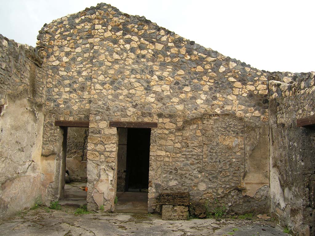 I.14.2 Pompeii. July 2008. Room B, looking north across atrium. 
On the left is the doorway to room L, in the centre is the doorway to room H.
Photo courtesy of Guilhem Chapelin. 
