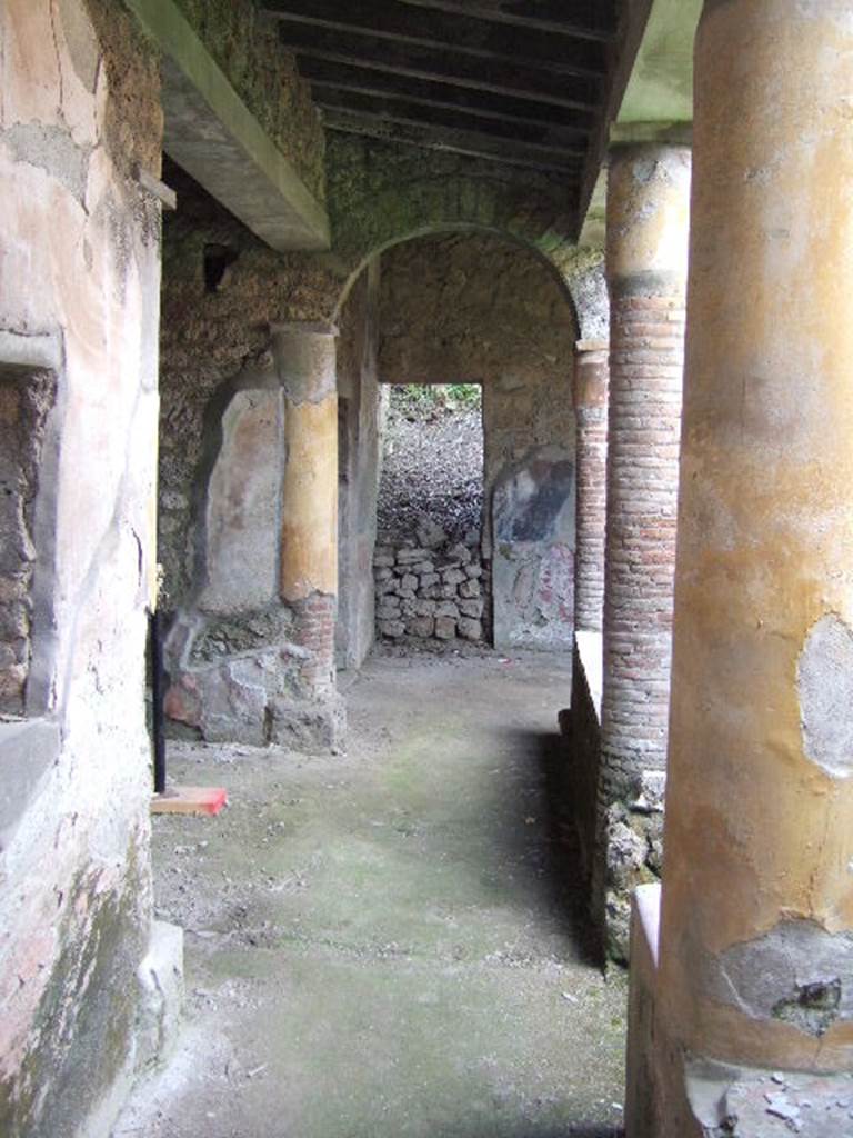 I.17.4 Pompeii. May 2006. Looking west along south portico.
At the far end can be seen the site of a staircase (now filled in again).