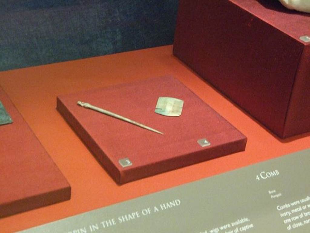 I.18.3 Pompeii.  Bone comb with two rows of teeth (on right). SAP 11883a. 
Photographed at �A Day in Pompeii� exhibition at Melbourne Museum. September 2009.
See D�Ambrosio, A., 2001. Women and Beauty in Pompeii. Roma: Bretschneider. (p. 27).
