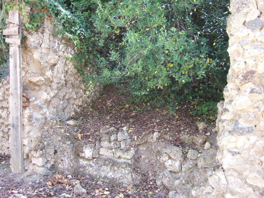 I.19.2 Pompeii. September 2005. When excavated, the area on the left of the photo would have been the podium (the two large slabs).
This was highly painted with two diamond shapes, on each side of a circle. According to Varone and Stefani, found on the west of the doorway was CIL IV 7384, no longer conserved.  See Varone, A. and Stefani, G., 2009. Titulorum Pictorum Pompeianorum, Rome: L�erma di Bretschneider, (p.170-171, with photo C.1951).
According to Epigraphik-Datenbank Clauss/Slaby (See www.manfredclauss.de), this read as �
Stabulio Oenoclioni bibis et 
mamillam quam tidi 
clupium [dedit(?)] ubiq(ue) Venus         [CIL IV 7384]
According to Stefani, a beautiful photo showing the decorated podium still being excavated can be seen, but with a note. This is photo SAP A2119.  The note said that the podium is now totally destroyed, and so it is difficult to know in which thermopolium the photo was taken.
According to the text, Stefani (and Varone and Stefani, above) recognise the thermopolium as being I.19.2.  See Stefani, G. (2005). Cibi e Sapori a Pompeii Dintorni. Pompeii, Flavius. (p.102, with photo A2119)
According to Della Corte, the host Stabilio was mentioned at least another four times in the near vicinity.  Twice on the sales counter, and twice not too far away, to the left of I.19.5. See Della Corte, M., 1965.  Case ed Abitanti di Pompei. Napoli: Fausto Fiorentino. (p.305)
According to Epigraphik-Datenbank Clauss/Slaby (See www.manfredclauss.de) these read as �
Cun(n)um  linge(s)  Stab(ilio)    [CIL IV 8419b]
]s Stabilio     [CIL IV 8419c]
Stabilio 
ceryssas ALS 
Stabilio        [CIL IV 8423] 

