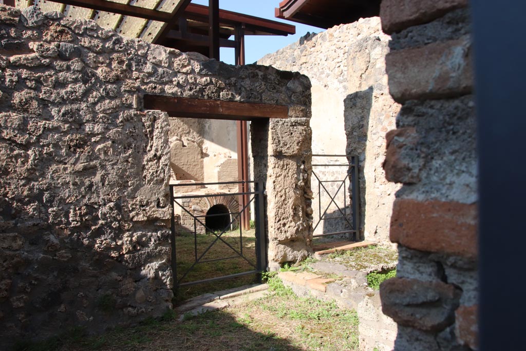I.20.2 Pompeii. October 2022. Looking north-west from I.20.2, towards doorway in I.20.3. Photo courtesy of Klaus Heese.