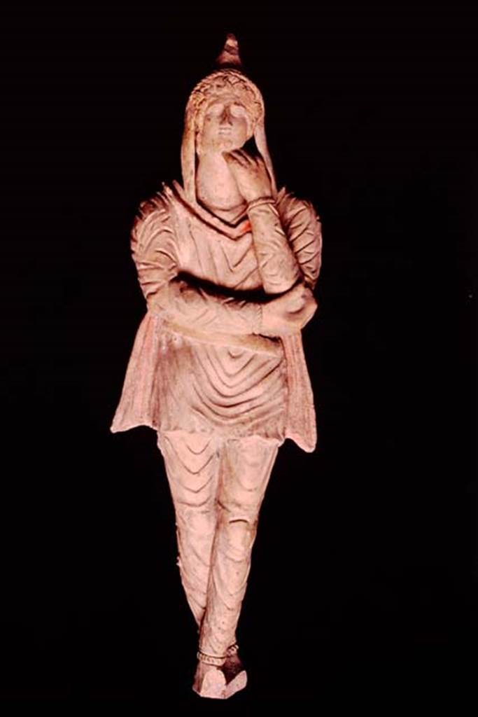Pompeii, 1982 or 1983. Terracotta statuette of Attis discovered in the area �next to the wall of the ancient well�.   
This is the first of two statuettes found. SAP inventory number 10309.
Source: The Wilhelmina and Stanley A. Jashemski archive in the University of Maryland Library, Special Collections (See collection page) and made available under the Creative Commons Attribution-Non Commercial License v.4. See Licence and use details.
J80f0498
See D�Ambrosio A. and Borriello M., 1990. Le terrecotte figurate di Pompei: SAP cat. 4. Roma: L�Erma di Bretschneider, p. 23, n. 16, Tav. V.
