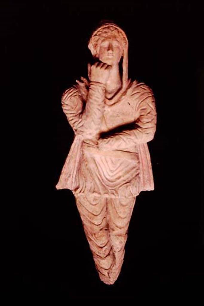 Pompeii, 1982 or 1983. Terracotta statuette of Attis discovered in the area �next to the wall of the ancient well�.   
This second statuette has the arms and legs positioned inverted and the hand that supports the chin is more closed compared to 10309. 
SAP inventory number 10310.
Source: The Wilhelmina and Stanley A. Jashemski archive in the University of Maryland Library, Special Collections (See collection page) and made available under the Creative Commons Attribution-Non Commercial License v.4. See Licence and use details.
J80f0500
See D�Ambrosio A. and Borriello M., 1990. Le terrecotte figurate di Pompei: SAP cat. 4. Roma: L�Erma di Bretschneider, p. 24, n. 17, Tav. V.

