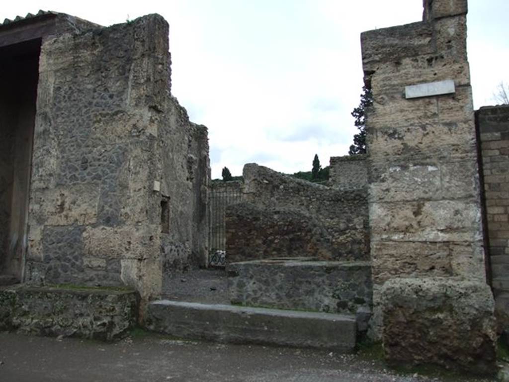 II.2.1 Pompeii. December 2006. Entrance doorway. According to Della Corte, originally it had been possible to obtain a partial plaster-cast of the door. The managers of the bar, in which many amphorae were found, were Astylus and Pardalus. He made this assumption from the electoral recommendation and a greeting traced to the left of the entrance: 
Astylus cup(it)    [CIL IV 7525]
Pardalus …. Gramulae  (?)  (salutem?)   [CIL IV 7528]
See Della Corte, M., 1965.  Case ed Abitanti di Pompei. Napoli: Fausto Fiorentino. (p.369)
Also found on the left of the entrance, between II.2.2 and II.2.1 was an electoral recommendation, which can be seen at II.2.3
According to Epigraphik-Datenbank Clauss/Slaby (See www.manfredclauss.de), these read as –
Helvium  Sabinum
aed(ilem)  o(ro)  v(os)  f(aciatis)  Astylus  cup[it]      [CIL IV 7525]
Parda[lus] Gramulae     [CIL IV 7528]
According to Garcia y Garcia, due to the bombing of 19th September 1943, the south and west wall of the caupona were destroyed.
The plaster-cast of the door was lost, and the sales-counter was badly damaged.  See Garcia y Garcia, L., 2006. Danni di guerra a Pompei. Rome: L’Erma di Bretschneider. (p.45, incl. fig 40 pre 1943 showing plaster-cast of door, and fig 41)
