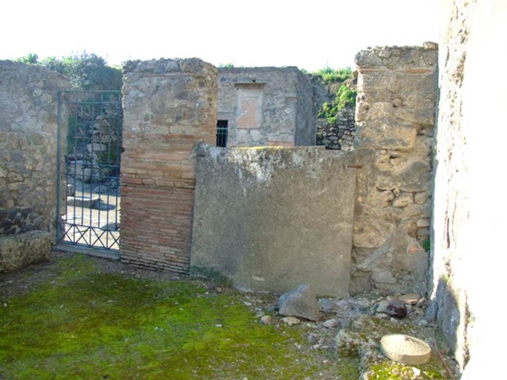 II.3.2 Pompeii. March 2009. Rear of plaster cast of doors, and II.3.1 entrance to stairs to upper floor, on north wall.