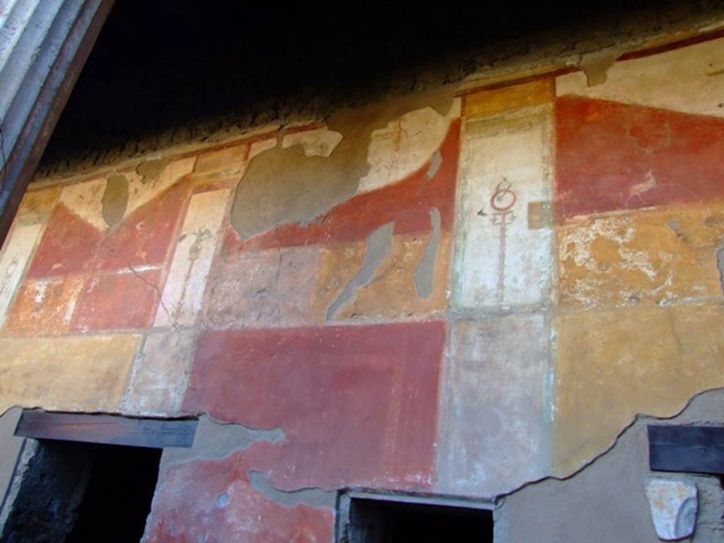 II.3.3 Pompeii. March 2009. Room 11, west portico with painted decoration above doorways to rooms 14 and 13.