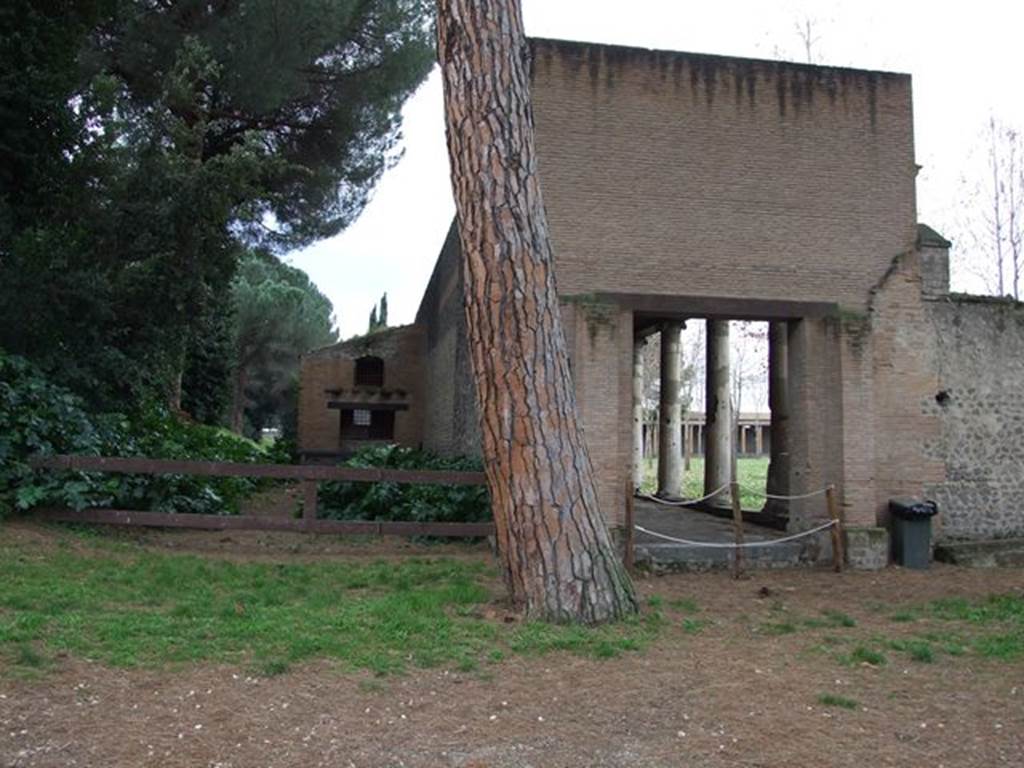 II.7.1 Pompeii. Palaestra. December 2006. Entrance.
According to Garcia y Garcia,
Many bombs, at least 10, fell in the internal and external areas, damaging the palaestra excavated between 1935-39. 
The first bombs fell during the night incursion of 20th September 1943; the others fell during the following days between 21st to the 26th September 1943.
One of the most beautiful of the plaster-casts made was of a man covering his face with his hands in a manner of true abandonment and resignation.  
He was found at the eastern extremity of the southern portico of the Palestra, and shown by Maiuri in the Pompeii Antiquarium, replaced in 1947 by a restoration that had altered notably the original form. (P.195 and note 78).
See Garcia y Garcia, L., 2006. Danni di guerra a Pompei. Rome: L’Erma di Bretschneider. 
