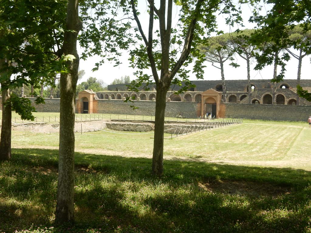 II.7.3 Pompeii. June 2019. Looking east across pool in Palestra, with entrance at II.7.4, left of centre, and II.7.3, right of centre.
Photo courtesy of Buzz Ferebee.
