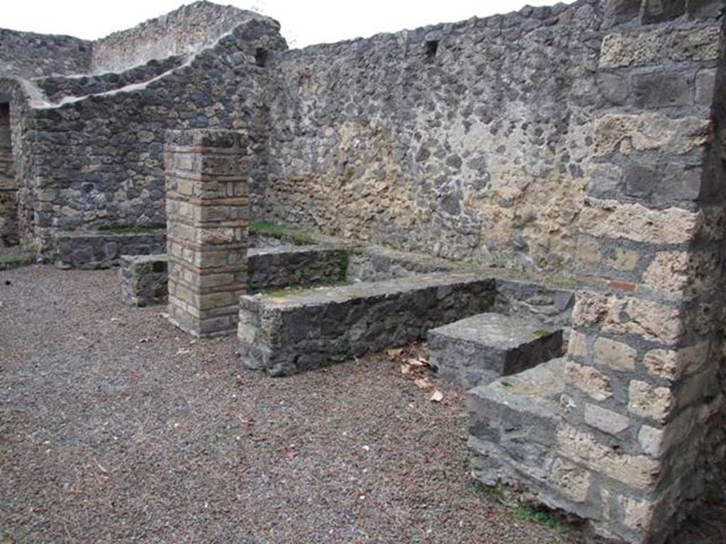 II.8.5 Pompeii. December 2007. Looking west across three-sided stone benches and tables built against the north wall. 