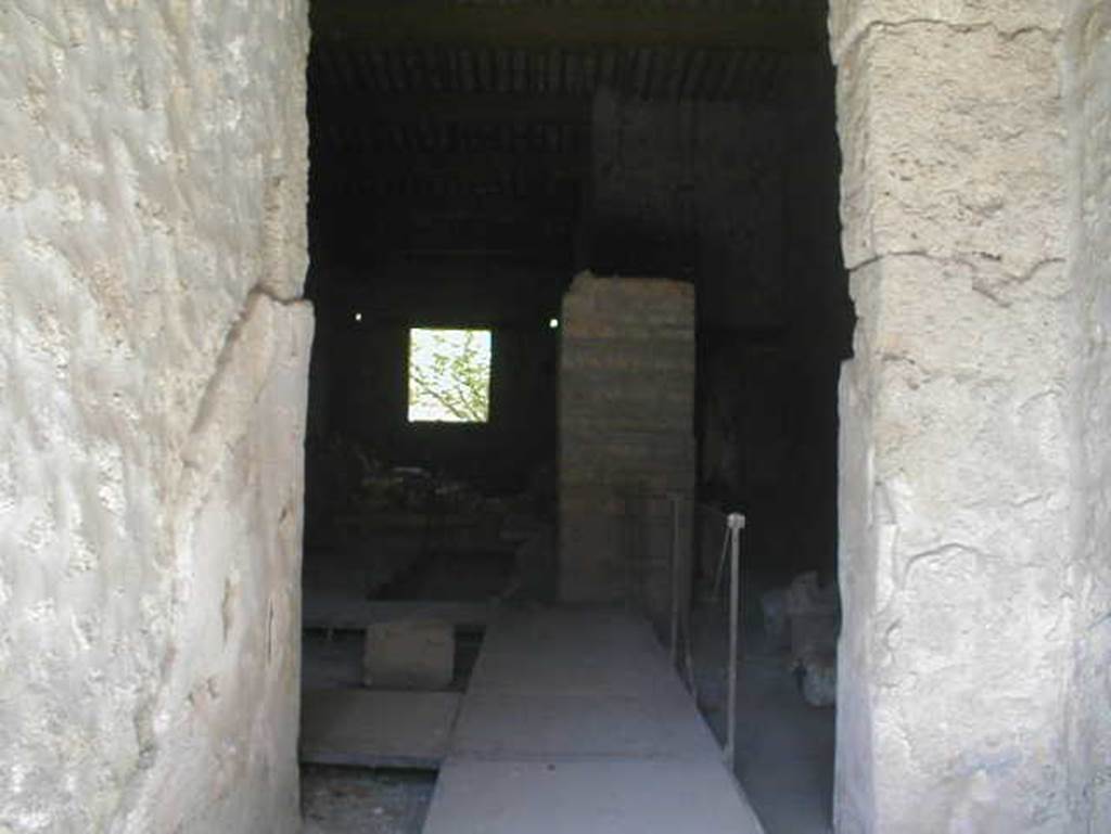 II.9.2 Pompeii. May 2005. Looking east from entrance corridor 1 into room 4. 
In room 4, close to the north wall, two bronze boxes were found containing objects of particular value: gems and work tools, which make the house attributable to a gemmarius or gem cutter.
The stones were yellow jasper, chalcedony-agate, chalcedony-Sardinian, chalcedony-carnelian, chalcedony-carnelian, chalcedony-carnelian, chalcedony-carnelian, chalcedony blue, prasio, quartz stone, rock crystal, and there were three chisels.
See Attivit� della Soprintendenza: Regio II, Insula 9: Rivista di Studi Pompeiani II, 1988, p. 200, p. 202 note 12.
