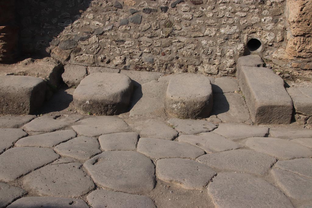 Blocked unexcavated roadway between III.1 and III.2, Pompeii. October 2023. Detail of stepping stones. Photo courtesy of Klaus Heese.