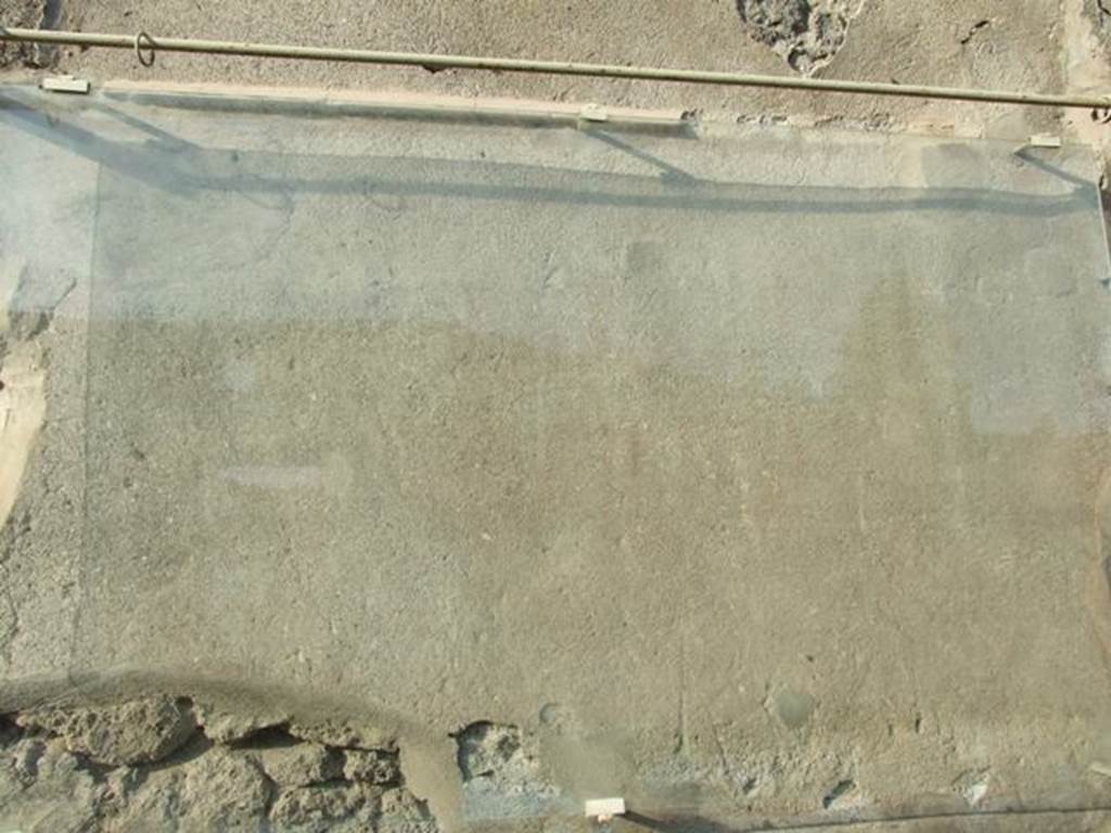 III.4.1 Pompeii. December 2007. Front exterior wall between III.4.1 and 2, on the east (right-hand) side of the blocked doorway. Glass protection above unreadable graffito CIL IV 7994. See Varone, A. and Stefani, G., 2009. Titulorum Pictorum Pompeianorum, Rome: L�erma di Bretschneider, (p.260-1)
According to Epigraphik-Datenbank Clauss/Slaby (See www.manfredclauss.de), this read as -
Par(ia)  XLIX  familia  Capinia  muneri[bus] 
Augustorum  pug(nabit)  Puteol(is)  a(nte)  d(iem)  [IV Idus Maias] 
pr(idie)  Mai(as)  et  XVII  XV  K(alendas)  Iu[n(ias)] 
vela  erunt  Magus       [CIL IV 7994]
According to Cooley, this was originally painted in red letters and translates as - 49 pairs. The Capinian troupe will fight at the games of the Augusti at Puteoli on (12), 14, 16 and 18 May. There will be awnings. Magus (wrote this). See Cooley, A. and M.G.L., 2004. Pompeii : A Sourcebook. London : Routledge. (p. 57).
