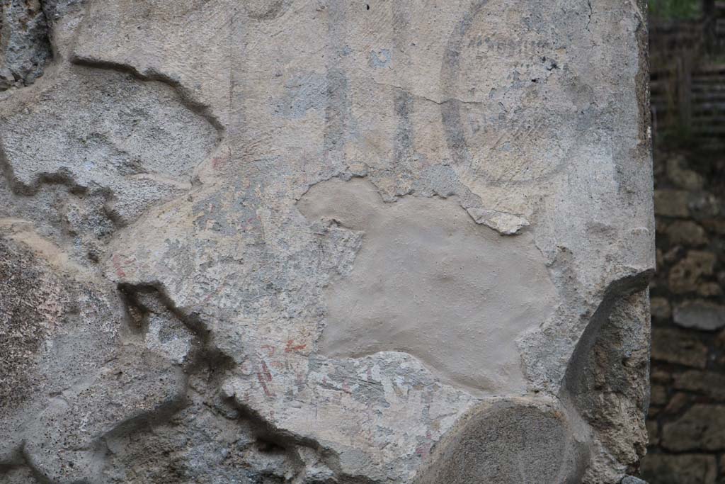 III.6.1 and III.6.2 Pompeii. December 2018. 
Detail of remaining painted inscription on front façade between two entrances. Photo courtesy of Aude Durand.

