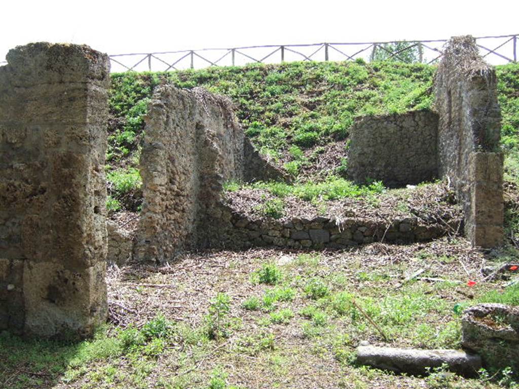 III.11.1 Pompeii. May 2006.  Looking south across Caupona. III.11.a (side entrance, one edge remains of the doorway in the west wall, on the right).


